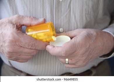 An Older Man Gets Ready To Take A Pill