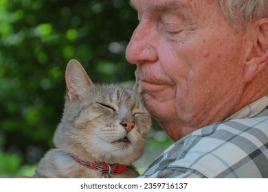 Older man with his cat - Powered by Shutterstock