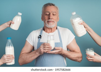 Older Man Holds A Glass Of Milk In His Hands. Cute Grandfather In An Apron Holding A Glass Of Milk, He Closed His Eyes And Enjoys The Organic Product