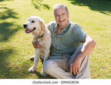 Older man hugging dog in backyard - Powered by Shutterstock