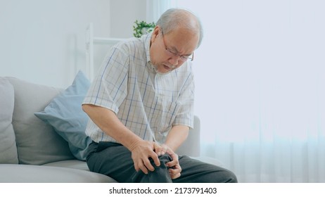 Older Man Are Hurting Their Legs. She Felt A Lot Of Pain. The Back Of The Leg Hit The Table. Woman Sitting On The Sofa At Home