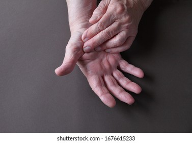 An Older Man Indicates An Area Of Pain On His Thumb 