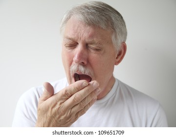 An Older Man Just Before Yawning Or Sneezing