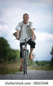 Older Man On His Bicycle In The Countryside