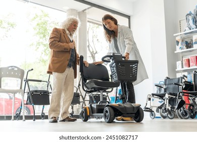 Older man in an orthopedic shop trying out an electric scooter - Powered by Shutterstock