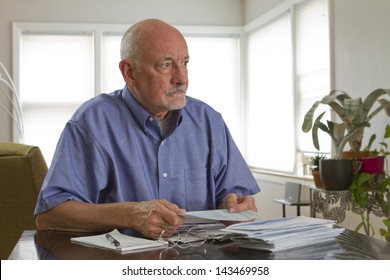 Older Man Paying Bills.