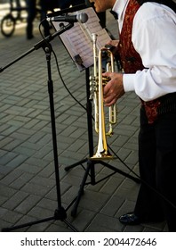 Older Man Playing Trumpet. Jazz Musician With Flugelhorn On Street Background. 