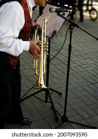 Older Man Playing Trumpet. Jazz Musician With Flugelhorn On Street Background. 