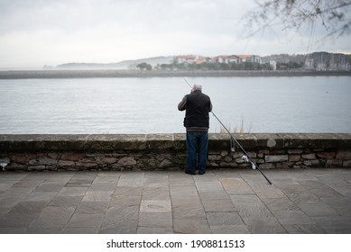 
Older Man Preparing The Rod For Fishing