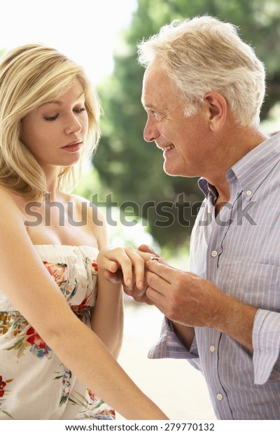 Older Man Proposing To\
Younger Woman