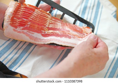 Older Man Pulls Slice Of Raw Bacon From Package