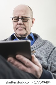 Older Man Reading On Tablet Pc