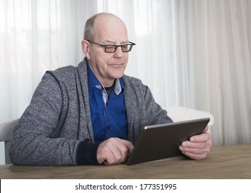 Older Man Reading On Tablet Pc