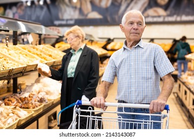 Older Man Shopping Buns And Bread In