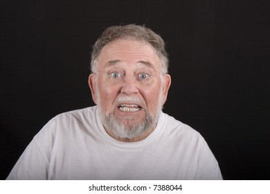 An Older Man Showing Shock Or Surprise Against A Black Background