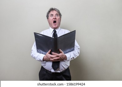 Older man singing in a choir - Shutterstock ID 1586199424