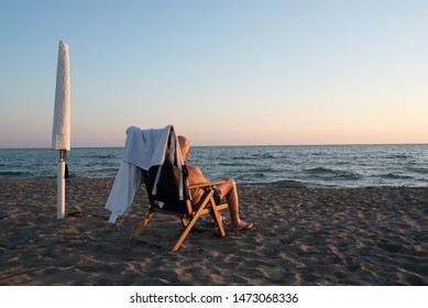 Older Man Sitting On The Beach