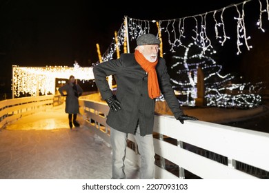 Older Man Skating On Ice And Having Fun During Christmas And Winter Time