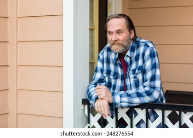 Older Man Standing On His Patio Smoking A Cigarette In Reno, Nevada, USA