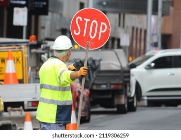 Older Man With A Stop Sign Directing Traffic In Sydney Cbd