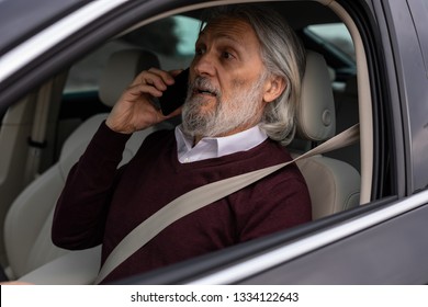 Older Man Is Surprised While Driving And Speaking On The Phone