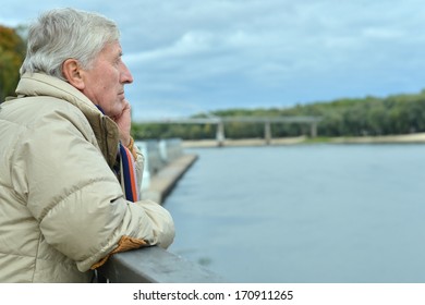 Older Man Thinking On The Bridge