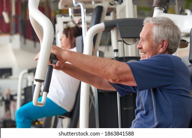 Older man training on press machine at gym club. Aged man training chest muscles using exercise machine at gym. Healthy brain, healthy body.