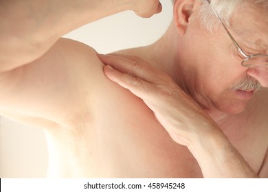 An Older Man Tries To Move His Shoulder Without Pain.