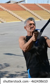 Older Man Trx Training In A Park