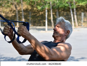 Older Man Trx Training In A Park