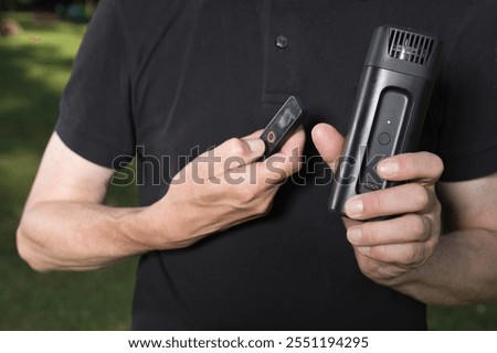 Older man uses two types of smoke machine generators on outdoor location