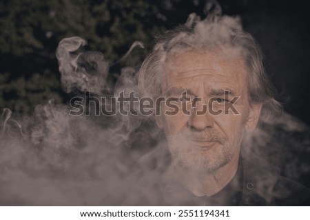 Older man uses two types of smoke machine generators on outdoor location