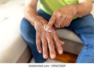 An Older Man Using Hand Cream Against Varicose Veins. Men's Hand Using Moisturizing Cream, Skin And Hand Care. Close Up View Of Mature Male Hands Moisturizing His Hands With Cream. Copy Space.