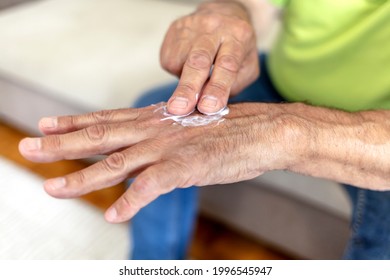 An Older Man Using Hand Cream Against Varicose Veins. Men's Hand Using Moisturizing Cream, Skin And Hand Care. Close Up View Of Mature Male Hands Moisturizing His Hands With Cream. Copy Space.