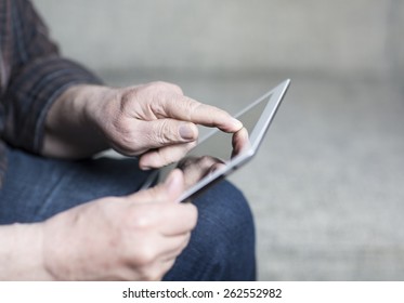 An Older Man Using A Tablet.