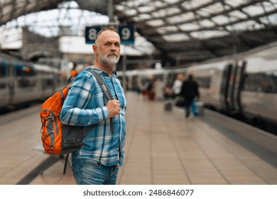 Older Man Waiting On Platform At Train Station - Powered by Shutterstock