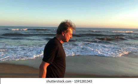 
Older Man Walking At The Beach