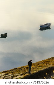 Older Man Walking By The Pier In The Morning (unrecognizable)