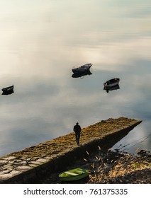 Older Man Walking By The Pier In The Morning (unrecognizable)