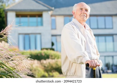 Older Man Walking With Cane Outdoors