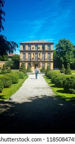 An Older Man Walking In A Landscaped Garden In Southern France.