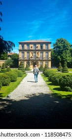 An Older Man Walking In A Landscaped Garden In Southern France.