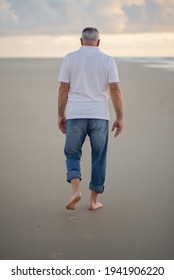 
Older Man Walking On The Beach