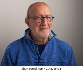 Older Man Wearing Glasses On A Plain Background