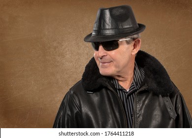 Older Man Wearing Leather Hat, Jacket And Sunglasses