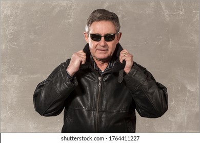 Older Man Wearing Leather Hat, Jacket And Sunglasses