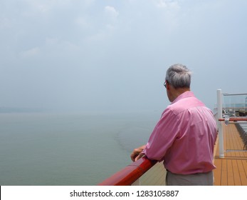 Older Man, Wearing Sunglasses Standing At The Railing Of Cruise Ship