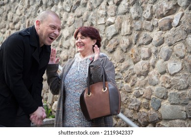 Older Man And Older Woman Laughing On A First Date