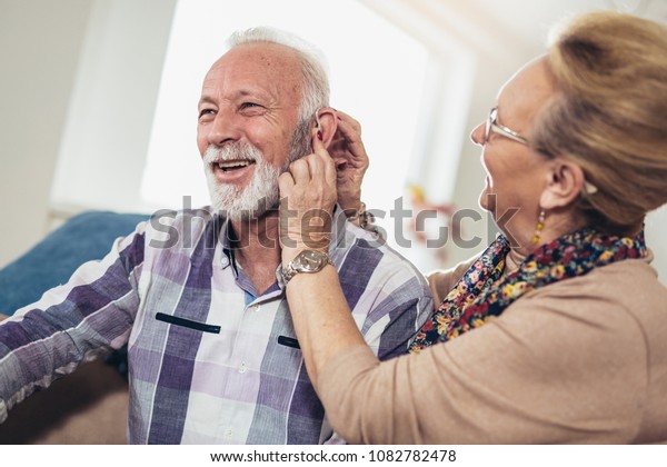 Older\
man and woman or pensioners with a hearing\
problem