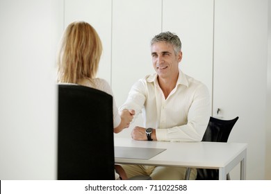 Older Man And Woman Shaking Hands